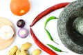 Top view of pestle and mortar with cooking ingredients over white background Royalty Free Stock Photo