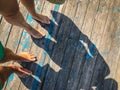 Top view, photo of bare feet and a pair of shadows on a wooden old floor. Photos on vacation, beach, summer Royalty Free Stock Photo