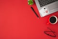 Top view photo of binder clips white sticker note paper on laptop plant pen glasses and red cup of coffee on isolated red Royalty Free Stock Photo