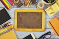 Top view photo of blank blackboard, old camera and school suppli Royalty Free Stock Photo