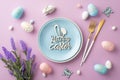 Top view photo of blue plate with inscription happy easter cutlery easter eggs bunny butterflies bunch of lavender flowers Royalty Free Stock Photo