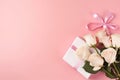 Top view photo of bunch of pink and white roses and gift box