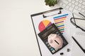 Top view photo of business workplace with keyboard glasses pen notebook plant piggy bank and calculator on pie chart diagram on Royalty Free Stock Photo