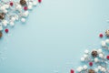 Top View Photo Of Christmas Decorations Snow Branches Red Berries And Pine Cones On Isolated Pastel Blue Background With Empty