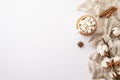 Top view photo of cup of hot chocolate with marshmallow on rattan serving mat knitted plaid cotton branch anise and cinnamon Royalty Free Stock Photo