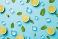 Top view photo of cut limes mint leaves ice cubes and water drops on isolated pastel blue background Royalty Free Stock Photo