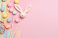 Top view photo of Easter bunny-shaped napkins, colorful easter eggs