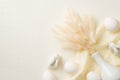 Top view photo of easter decorations white vase with bunch of lagurus flowers two ceramic bunnies white easter eggs and cloth on Royalty Free Stock Photo