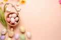 Top view photo of Easter-themed items including colorful eggs, small baskets, ceramic bunnies Royalty Free Stock Photo