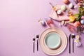 Top view photo of a festive Easter table setting with pastel-colored plates