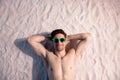 Top view photo of funky dreamy shirtless man lying sand hands behind head outdoors seaside beach Royalty Free Stock Photo