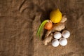 Top view photo of a ginger, lemon, 4 eggs and green onion isolated on sacking background