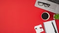 Top view photo of glasses on laptop flowerpot red cup of coffee binder clips white sticker note paper and pen on open spiral Royalty Free Stock Photo