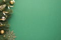 Top view photo of gold and silver christmas tree balls toy cone small bells snowflake and serpentine on pine twigs on isolated