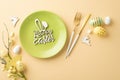 Top view photo of green plate with text happy eater fork knife colorful easter eggs easter bouquet and bunnies Royalty Free Stock Photo