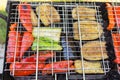 Top view photo of a grilled vegetables, peppers, eggplants and courgette on the chargrill. Outdoor picnic