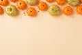 Top view photo of halloween glamorous decorations composition orange and golden small pumpkins golden stars sequins on isolated