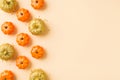 Top view photo of halloween glamorous decorations orange and golden small pumpkins golden sequins on isolated beige background