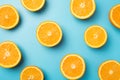 Top view photo of juicy orange slices on isolated light blue background Royalty Free Stock Photo