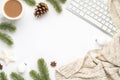 Top view photo of keyboard cup of hot drinking white christmas tree decorations balls star pine twigs cone anise and scarf on Royalty Free Stock Photo