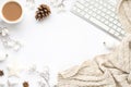 Top view photo of keyboard cup of hot drinking white christmas tree decorations balls star snow twigs cone anise and scarf on Royalty Free Stock Photo