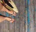 Top view, photo of legs in beach flip-flops and with a straw bag in hand on a wooden old floor. Photos on vacation, beach, summer Royalty Free Stock Photo