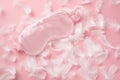 Top view photo of light pink satin sleeping mask and pink feathers on isolated pastel pink background with copyspace Royalty Free Stock Photo