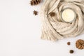 Top view photo of lighted candle in candlestick sweater pine cones and anise on isolated white background with blank space