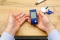 Top view photo of man hands holding stripe and glucometer for checking blood sugar level at home, diabetes concept. Royalty Free Stock Photo