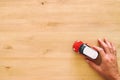top view photo of man& x27;s hand holding toy car over wooden background. Royalty Free Stock Photo