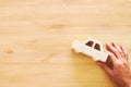 top view photo of man& x27;s hand holding toy car over wooden background. Royalty Free Stock Photo