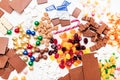 Top view photo of many sweets chocolate and caramels on white table