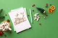 Top view photo of merry christmas wooden text diary pen pine branch mug of cocoa with marshmallow wood deer ornament mistletoe Royalty Free Stock Photo