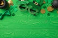 Top view photo of the nice Irish glasses with hats black two bowlers and a lot of coins inside and around them soft confetti in