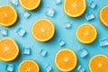 Top view photo of orange slices ice cubes and water drops on isolated light blue background Royalty Free Stock Photo