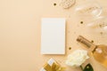 Top view photo of paper sheet white giftbox with gold bow two wineglasses wine bottle sequins white rose and heart shaped golden