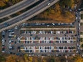 Top view photo of parking lot near bridge of road junction and city park taken by drone Royalty Free Stock Photo