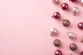 Top view photo of pink christmas tree decorations balls on isolated pastel pink background with empty space Royalty Free Stock Photo
