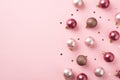 Top view photo of pink christmas tree decorations balls and shiny confetti on isolated pastel pink background with blank space Royalty Free Stock Photo