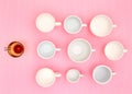 Top view photo of plenty variety of clean white elegant porcelain coffee or tea cups und one red glass cup. Royalty Free Stock Photo