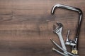 Top view photo of plumbing tools over wooden background with copy space.