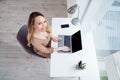 Top view photo of remote worker lady sit workplace typing netbook look up wear beige shirt in cozy office indoors