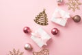 Top view photo of row composition christmas tree decorations pink balls gold bell pine snowflake shaped ornaments white gift boxes Royalty Free Stock Photo