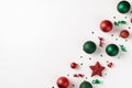 Top view photo of row composition red and green christmas tree decorations balls star serpentine and confetti on isolated white
