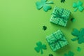 Top view photo of saint patrick`s day decorations two green gift boxes with polka dot pattern clover shaped confetti and shamrock Royalty Free Stock Photo