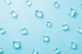 Top view photo of scattered melting ice cubes on isolated light blue background Royalty Free Stock Photo