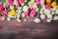 Top view photo of scattered pink, yellow and white tulips, daisies and baby\'s breath