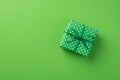 Top view photo of st patrick`s day decorations green giftbox with polka dot pattern on isolated pastel green background with Royalty Free Stock Photo
