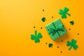 Top view photo of st patrick`s day decorations green giftbox with polka dot pattern surrounded by shamrocks and clover shaped Royalty Free Stock Photo