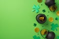 Top view photo of st patrick`s day decorations pots with gold coins green shamrocks and clover shaped confetti on isolated pastel